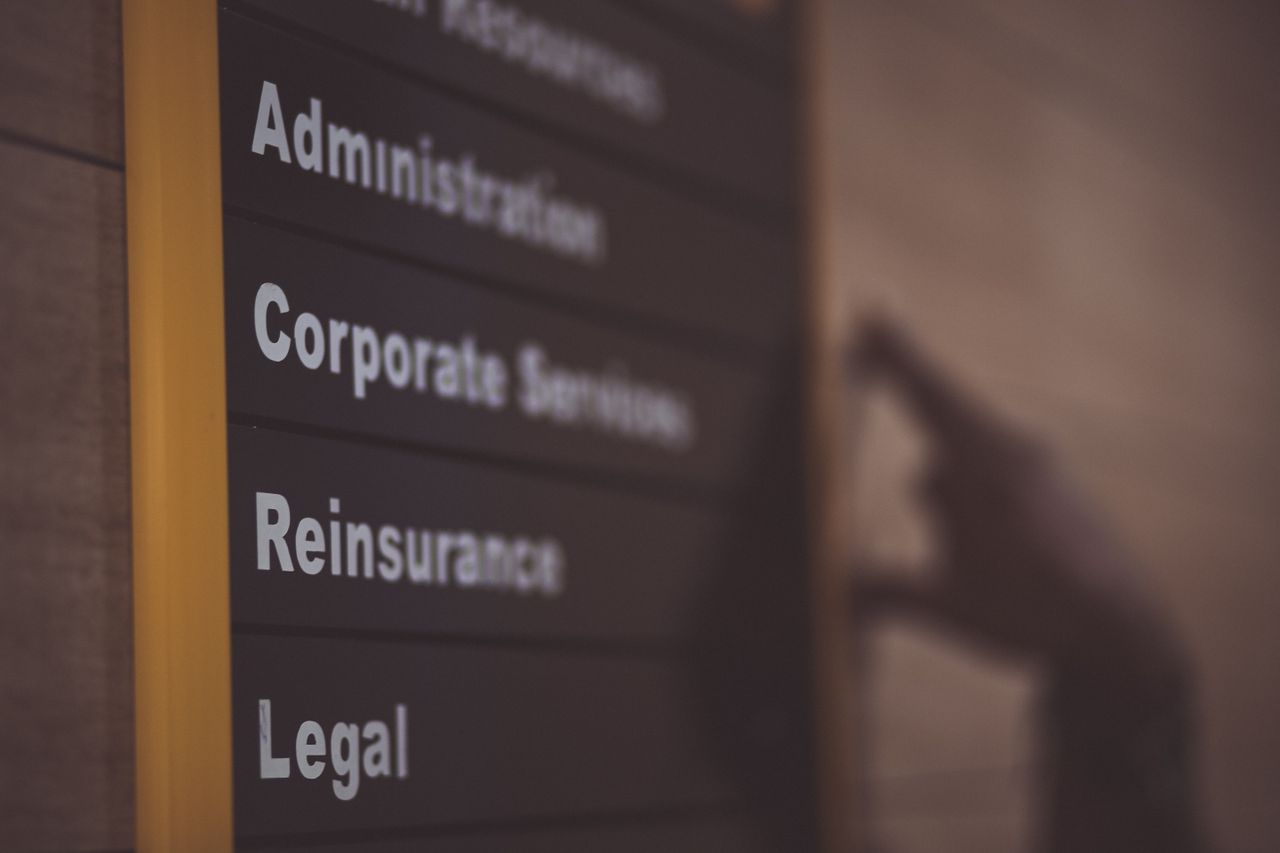who-we-are Close-up of an office directory sign showing administration and legal departments.