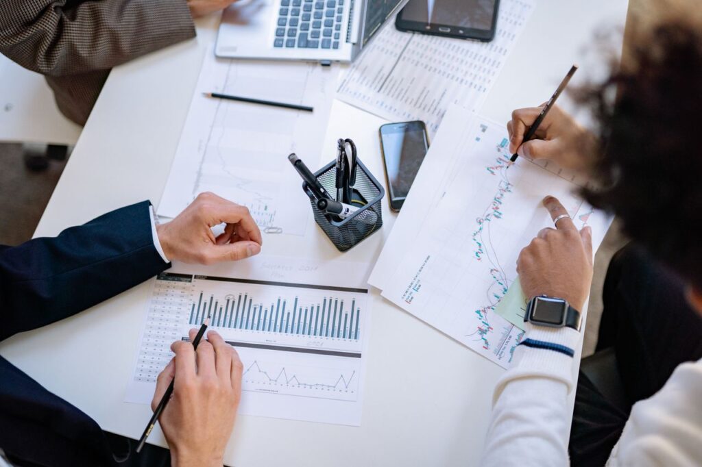 pexels photo 7698796 Business team analyzing financial charts and graphs during a collaborative meeting.